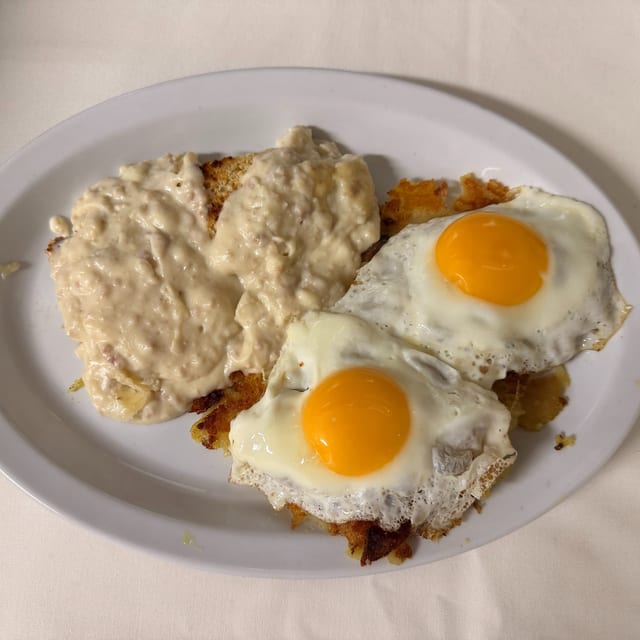 Sausage Gravy Over Biscuits with Two Eggs.